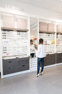 Caroline selecting eyeglass frames from LensCrafters